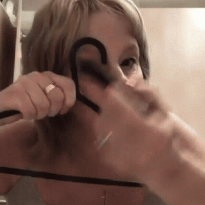 Woman With Ring Holding Hanger GIF