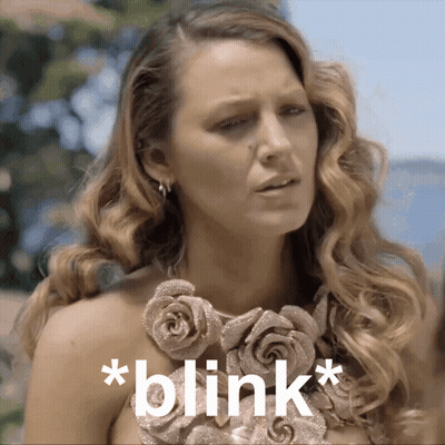 Woman With Rose Necklace Saying Blink GIF
