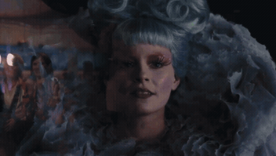 Woman With Scarf Standing In Crowd GIF
