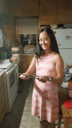 Woman With Scary Smile While Sharpening Knife GIF