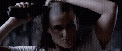 Woman With Shaved Head Holding Bottle GIF