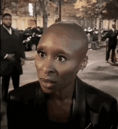 Woman With Shaved Head in Crowded Street