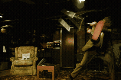 Woman With Shaved Head Sitting Cross-Legged On Table GIF