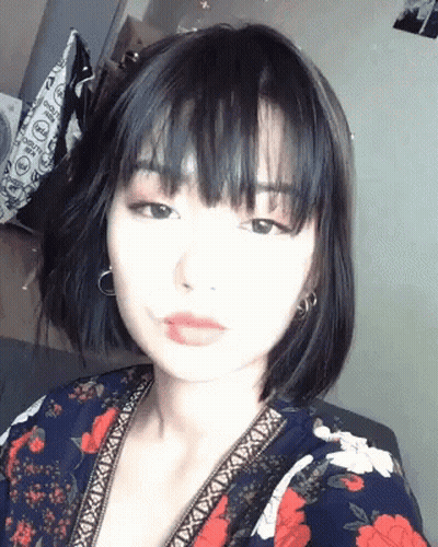 Woman With Short Black Hair Taking Selfie GIF