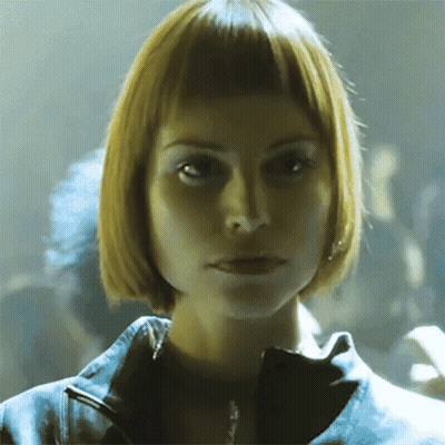 Woman With Short Blonde Hair Looking At Camera GIF