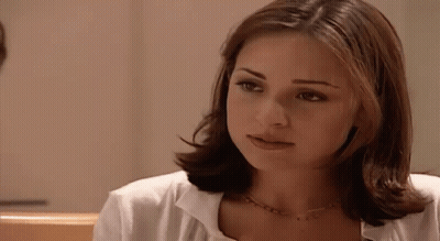 Woman With Short Brown Hair in White Shirt and Gold Necklace
