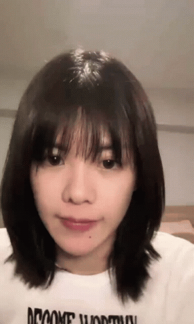 Woman With Short Hair And Bangs In White Shirt GIF