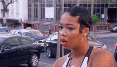 Woman With Short Hair And Red Lipstick In Parking Lot GIF