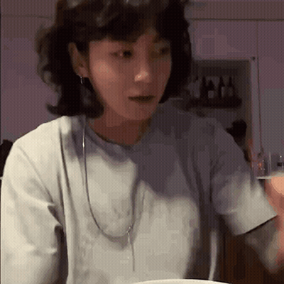 Woman With Short Hair At Table With Food GIF