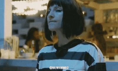 Woman With Short Hair In Striped Shirt And Earrings GIF