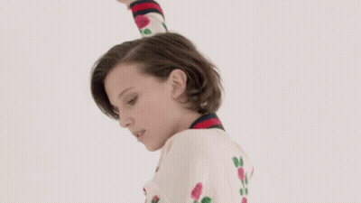 Woman With Short Hair In White Sweater With Roses GIF