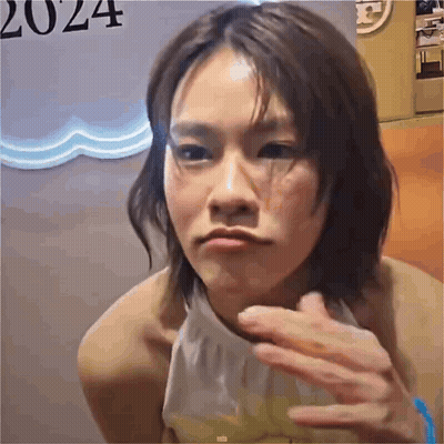 Woman With Short Hair Making Funny Face In Front Of 2024 Sign GIF