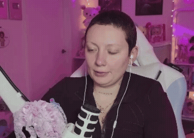 Woman With Short Hair Sitting In Chair With Headphones GIF