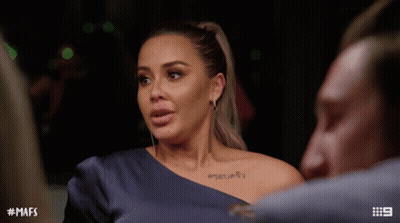 Woman With Shoulder Tattoo Talking To Man GIF