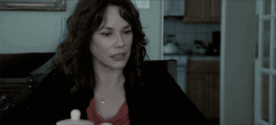 Woman With Small White Container At Table GIF