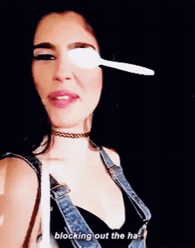 Woman With Spoon In Eye Blocking Out The Ha GIF