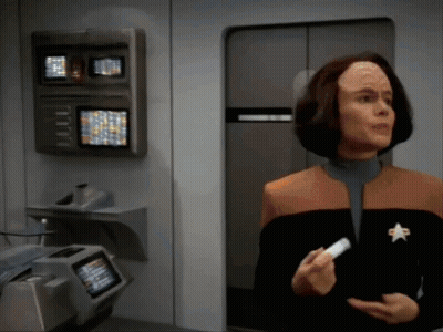 Woman With Star Jacket Holding White Item GIF