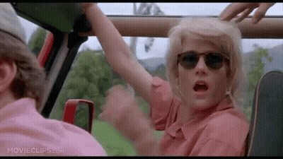 Woman With Sunglasses Arm Outstretched In Car GIF