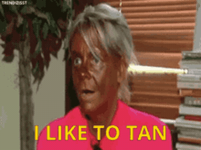 Woman With Tan Saying I Like To Tan GIF