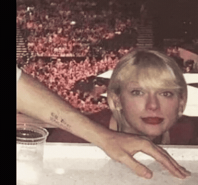 Woman With Tattoo Sitting Next To Man's Hand GIF