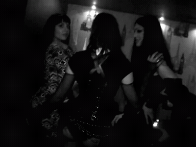 Woman With Tattoo Standing Next To Another Woman GIF