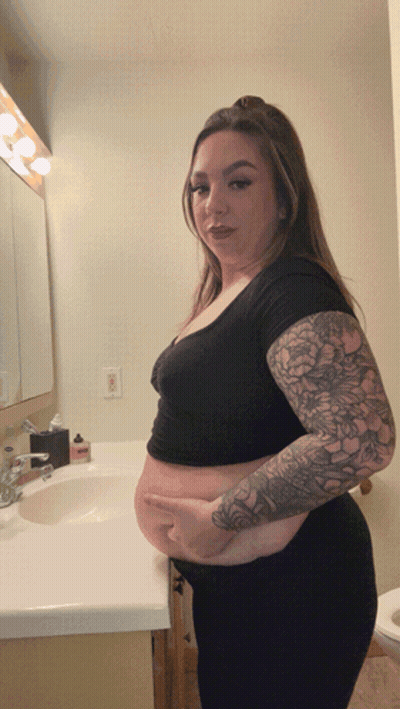 Woman With Tattoos At Bathroom Sink GIF