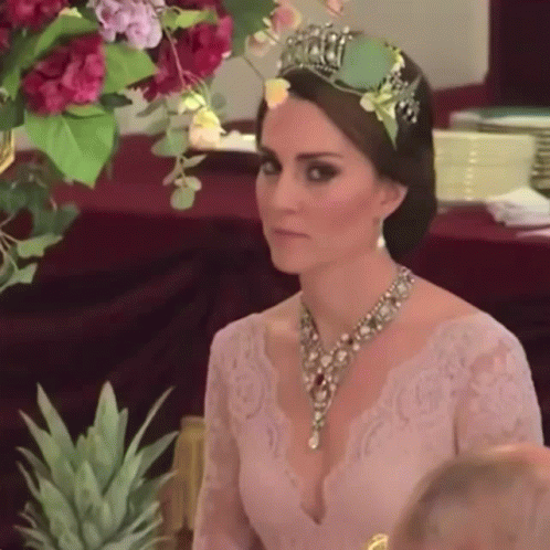 Woman With Tiara And Necklace At Table GIF