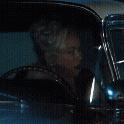 Woman With Tiara Driving Car At Night GIF