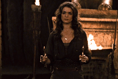 Woman With Torch In Front Of Fire GIF