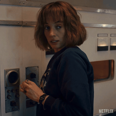 Woman With Watch Next To Netflix Logo GIF