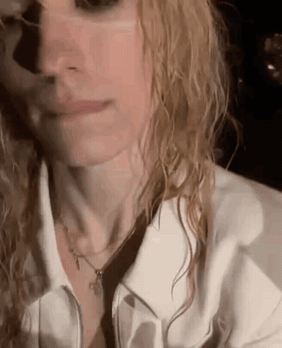 Woman With Wet Hair White Jacket And Necklace GIF
