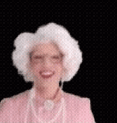 Woman With White Hair And Glasses Smiling In Pink Dress GIF