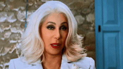 Woman With White Hair And Red Lipstick At Blue Door GIF