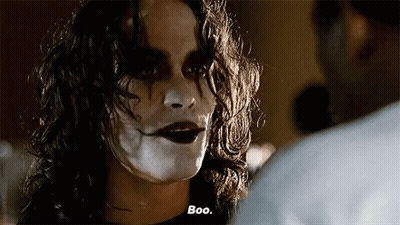 Woman With White Paint On Face Talking To Man In Dark Room GIF