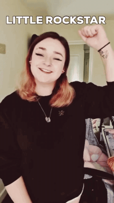 Woman With Wrist Tattoo Fist Up Little Rockstar GIF
