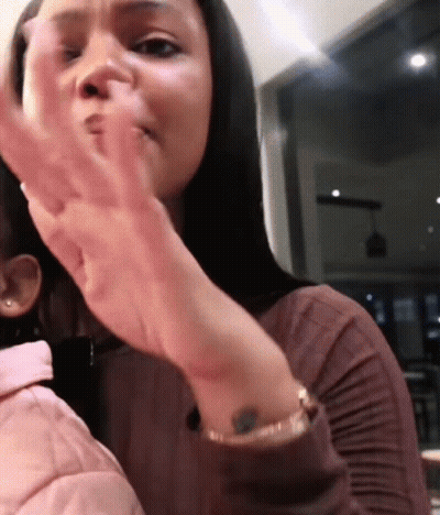 Woman With Wrist Tattoo Holding Child GIF