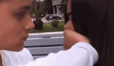 Woman With Yellow Flower In Mouth GIF