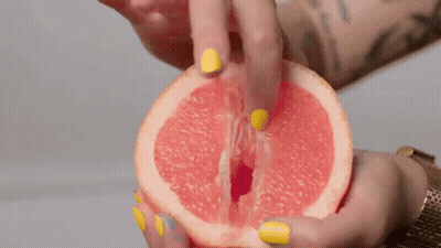 Woman With Yellow Nails Holding Grapefruit GIF