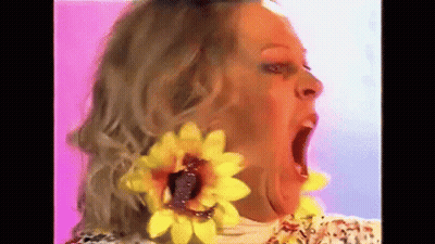 Woman With Yellow Sunflower Earrings Making Funny Face GIF