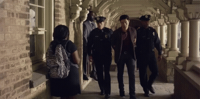 Woman With Zebra Print Backpack Walking With Two Police Officers GIF