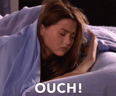 Woman Wrapped In Blue Blanket Saying Ouch GIF