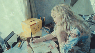 Woman Writing At Desk Next To Dot Box GIF