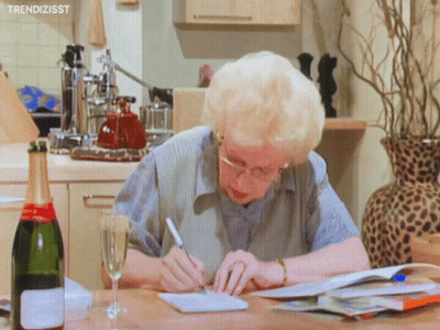 Woman Writing Next To Champagne Glass GIF