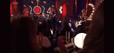 Women Clapping At Table In Dark Room GIF