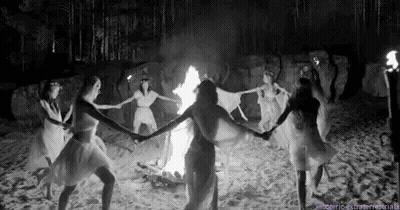 Women Dancing Around Fire On Beach GIF