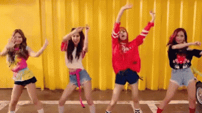 Women Dancing By Yellow Wall GIF