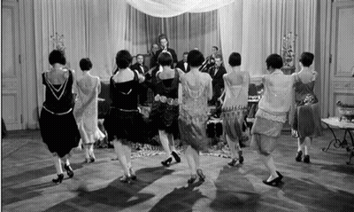Women Dancing In Circle In Front Of Band GIF