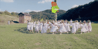 Women Dancing In Field With Cartoon Hanging GIF