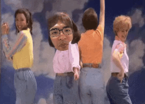 Women Dancing In Front Of Blue Sky With Man With Glasses On Head GIF