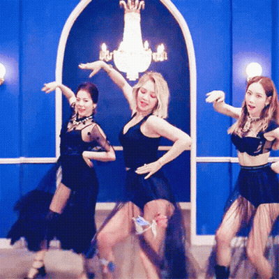 Women Dancing In Front Of Blue Wall GIF